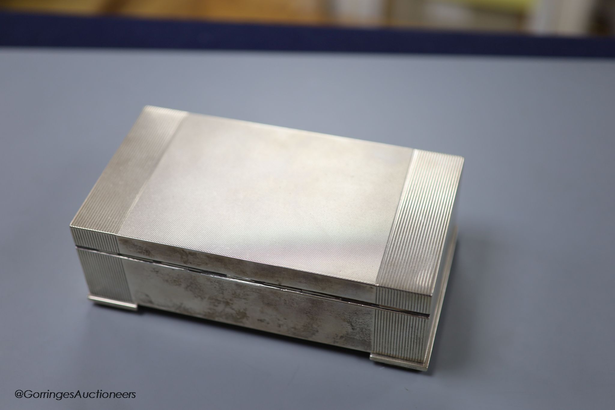 An engine-turned silver rectangular cigarette box, by Garrard & Co Ltd,